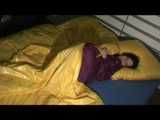 ENNI wearing a sexy purple shiny nylon rain suit lying in bed with yellow shiny nylon cloths lolling and posing (Video)