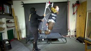 Rachel Adams bound, gagged and suspended in shiny nylon Down