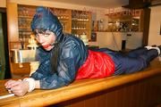An archive girl tied and gagged on a bar wearing shiny nylon rainwear (Pics)
