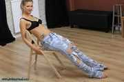 Hot jeans girl cuffed on a chair