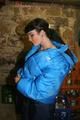 Jill posing in a cooling room wearing a shiny nylon rainpants and a down jacket (Pics)