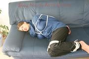 Katharina tied, gagged and hooded (breath control) on a sofa wearing sexy shiny nylon rainwear (Pics)