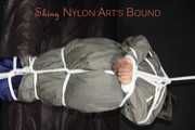 Sexy Sandra being tied and gagged overhead with ropes and a clothgag hodded wearing a sexy rainwear combination (Pics)