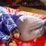 Sonja tied, gagged and hooded on bed with cuffs wearing a sexy grey shiny nylon rain pants and a blue down jacket (Pics)