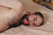 Amanda undresses and ties a man into hogtie and gag him