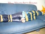 Leoni tied, gagged and hooded with tape wearing a sexy blue rainwear combination (Pics)