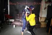 Sandra beeing tied and gagged by Stella in Shiny Nylon Rainwear crotchrope-suspended 