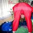Leonie playing with nylon clothes ans posing sexy infront of the camera wearing sexy shiny nylon rainwear (Pics)