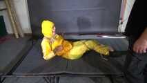 Ms Ungeniert tied and gagged in shiny nylon Rainwear trying to escape