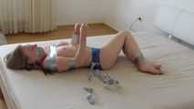 Maria in tape on bed 4/4