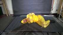 Ms Ungeniert tied and gagged in shiny nylon Rainwear trying to escape