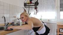 Busty blonde maid Cara cleans the kitchen