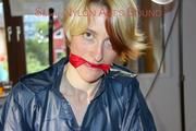 Sonja tied and gagged standing on a chair wearing a sexy red shiny nylon shorts and a darkblue rain jacket (Pics)