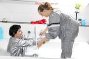 Simone in an shiny grey pvc sauna suit tied and gagged by Sophie in the bath tub (pics)