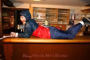 Jill tied and gagged in shiny rainwear