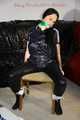 Lucy tied and gagged with rope and gag on a chair wearing a sexy black shiny nylon jumpsuit (Pics) 