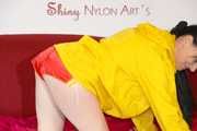 Lucy wearing a sexy red shiny nylon shorts and a yellow rain jacket preparing the sofa to lay down (Pics)