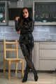 Miss Amira im sexy Lackcatsuit und Regenmantel fixiert und geknebelt