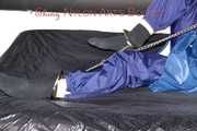 Lucy tied with cuffs overhead and gagged with a clothgag wearing sexy blue rain pants and a raincoat (Pics)