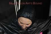 Sexy Mara tied, gagged and hooded overhead on hands and feet with ropes and a cloth gag wearing a sexy black/pink rainwear combination (Pics)