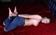 Tapegagged topless barefoot Peggy, hogcuffed with heavy steel cuffs