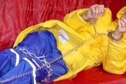 Sonja tied, gagged and hooded on a sofa wearing a sexy blue rain pants and a yellow downwear jacket (Pics)
