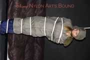 Sexy Sandra being tied and gagged overhead with ropes and a clothgag hodded wearing a sexy rainwear combination (Pics)