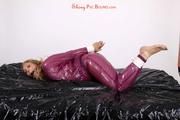 Sophie in an shiny transparent purple PVC suit tied and gagged in bed (Pics)