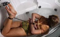 Ballgagged barefoot Albina Rose in bikini, hogtied with rope, wiggles in water in jacuzzi