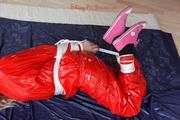 Nina tied and gagged in a shiny red PVC suit
