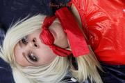 Nina tied and gagged in a shiny red PVC suit