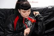 Jill bound and gagged in a shiny nylon skisuit