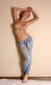 Topless barefoot Samira, cuffed with steel cuffs, poses to the camera