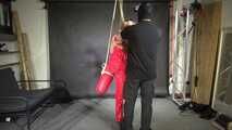 Marie bound, gagged and suspended in a shiny nylon Jumpsuit