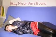 Mara ties and gagges herself with hand cuffs on a sofa wearing a supersexy black Leggings and a shiny nylon shorts and a rain jacket (Pics)