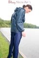 Sexy archive girl wearing a blue rain pant and rain jacket walking on a lake in freetime (Pics)