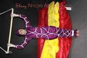 Watching sexy Sonja wearing a supersexy purple shiny nylon rainwear combination being tied and gagged overhead with ropes and a clothgag (Pics)