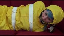 Mara tied and gagged with tape on a sofa wearing a sexy shiny yellow rainwear combination (Video)