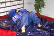 Lulu ties, gagges and hoodes herself on a bed with cuffs wearing a sexy black/blue shiny nylon down jacket and a darkblue rain pants (Pics)