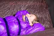 *** HOT HOT HOT*** NEW MODELL*** SANDRA wearing a sexy transparent purple shiny nylon pants and a purple down jacket tied and gagged on a sofa with ropes hand to feet and a cloth gag (Pics)
