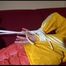 Lucy tied, gagged and hooded on a red sofa wearing a sexy orange shiny nylon pants and a yellow rain jacket (Video)