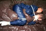 Stella tied and gagged in shiny nylon rainwear