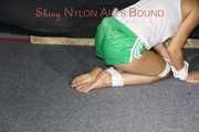 Watching sexy Sandra wearing a sexy green shorts and a white top being tied and gagged on the floor with ropes and a cloth gag (Pics)