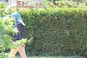 Mara wearing a purple shiny nylon shorts and a black rain jacket playing soccer (Pics)