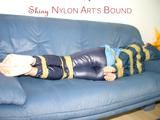 Leoni tied, gagged and hooded with tape wearing a sexy blue rainwear combination (Pics)
