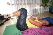 Stella tied and gagged on the floor wearing a shiny nylon rain pants (Pics)