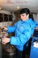 Jill posing in a cooling room wearing a shiny nylon rainpants and a down jacket (Pics)
