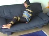 A video with one of our archive girls tied and gagged in shiny nylon rainwear