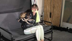 Marie bound and gagged in a shiny nylon Downjacket