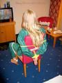 Blonde archive girl tied and gagged in an green shiny nylon rainsuit on a chair (Pics)
